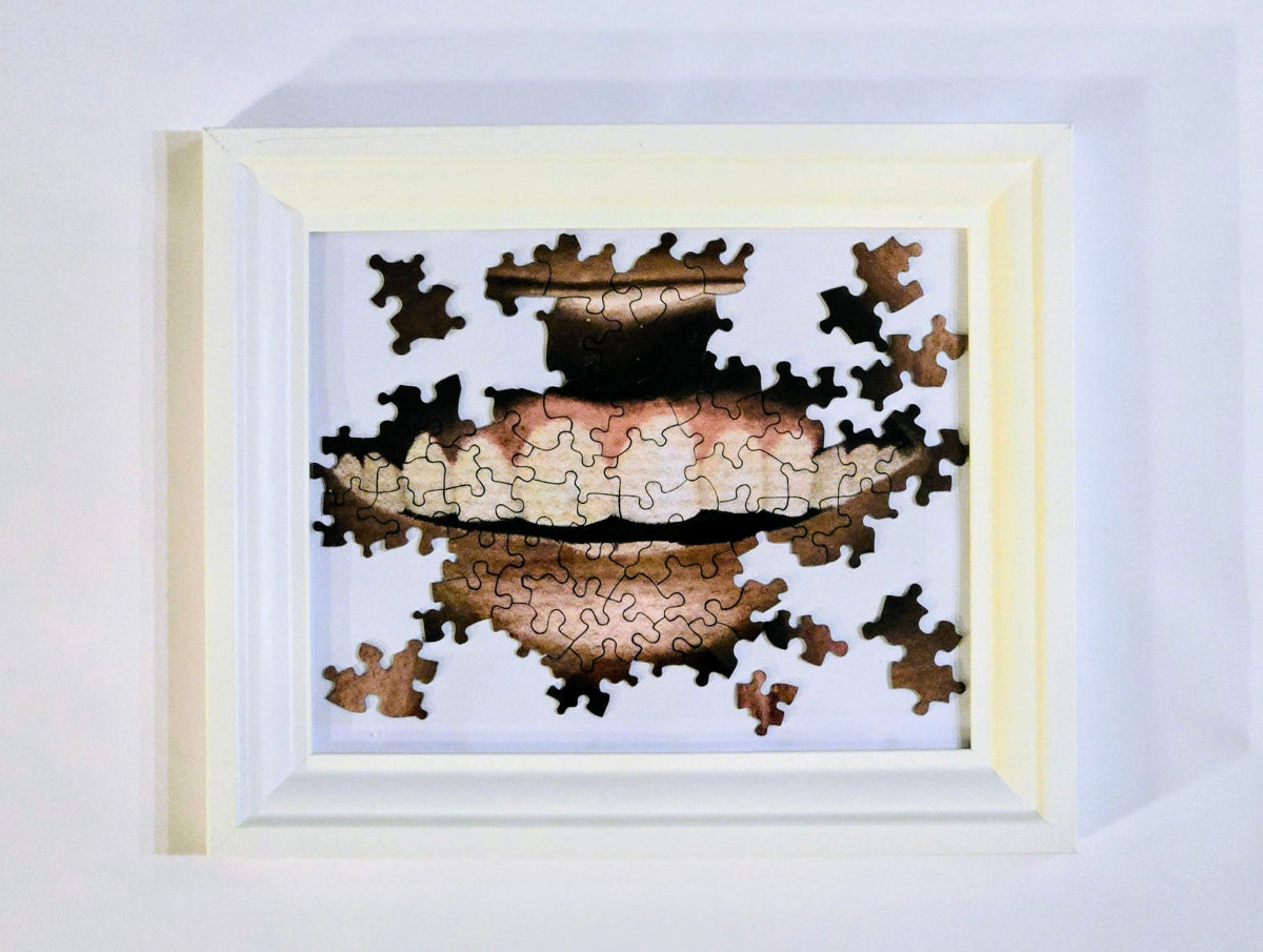 Framed puzzle with a completed design on a white background