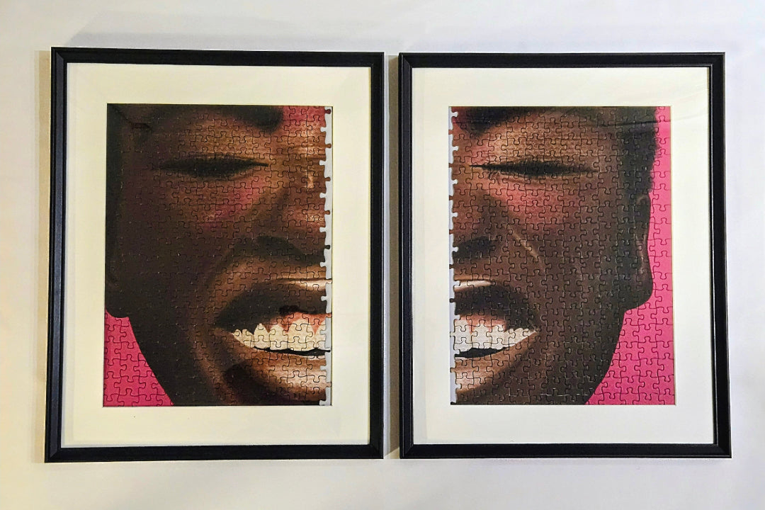 Two framed artworks of a person's face with a pink background on a white wall.
